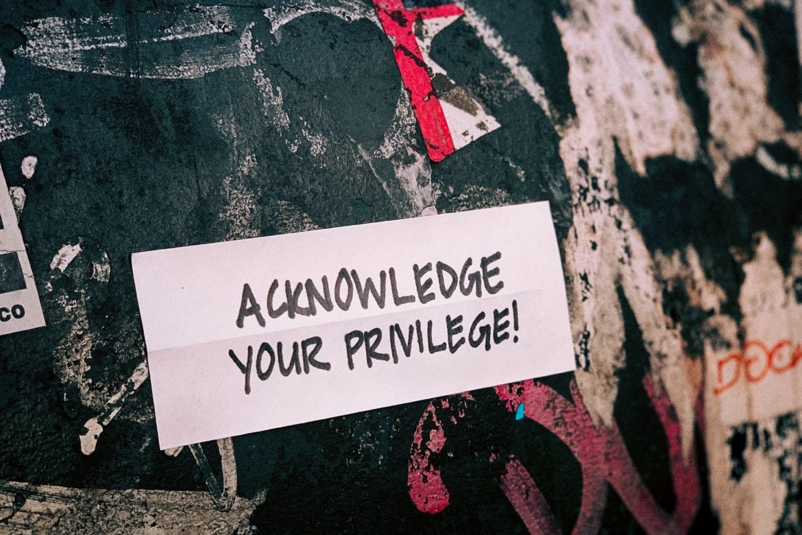 The words 'Acknowledge Your Privilege' are set against a black, white and red background.