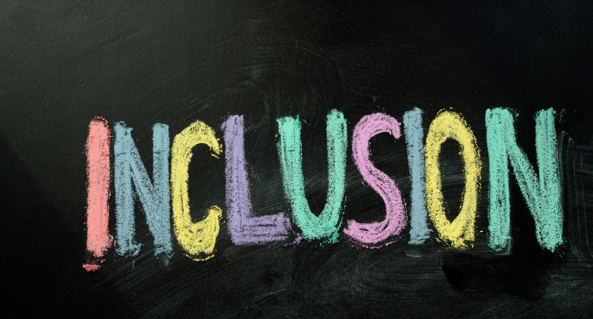 A blackboard with the word 'inclusion' written in coloured chalk.